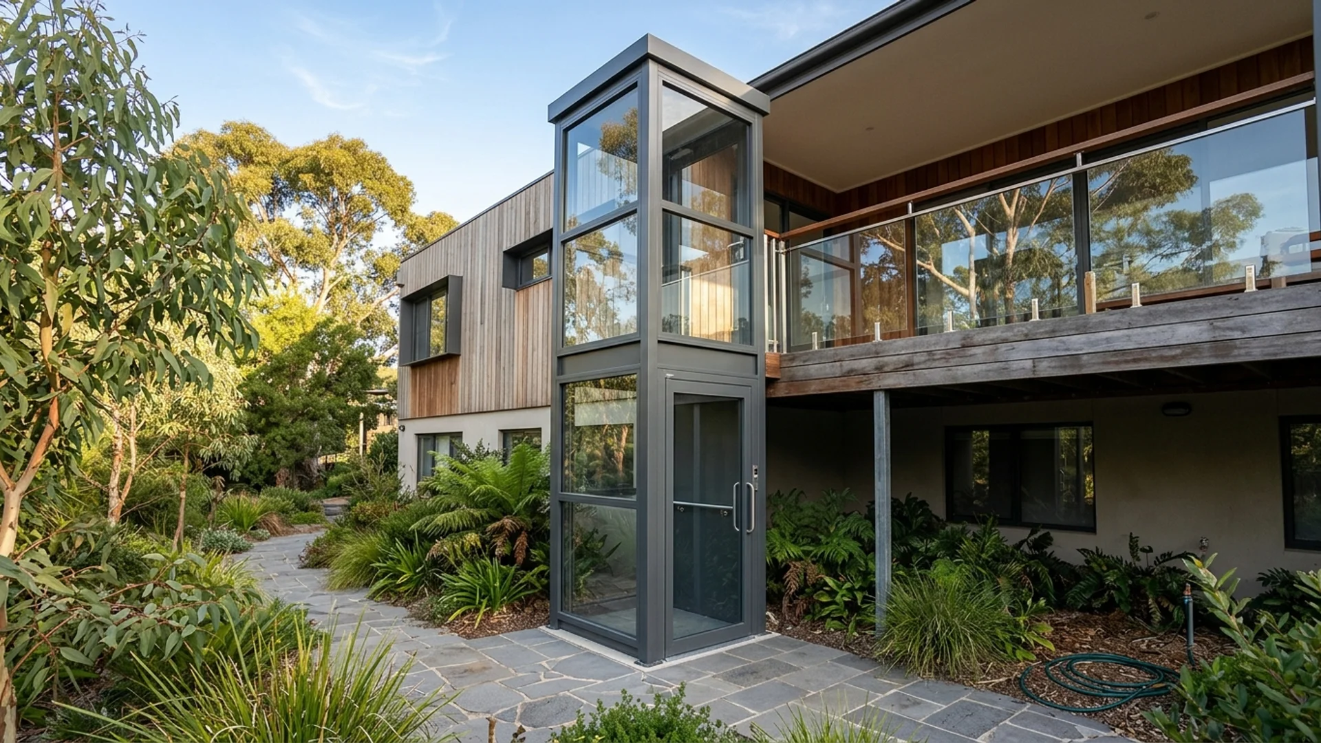 Outdoor platform lift installed beside an Australian home with garden setting and weather protection